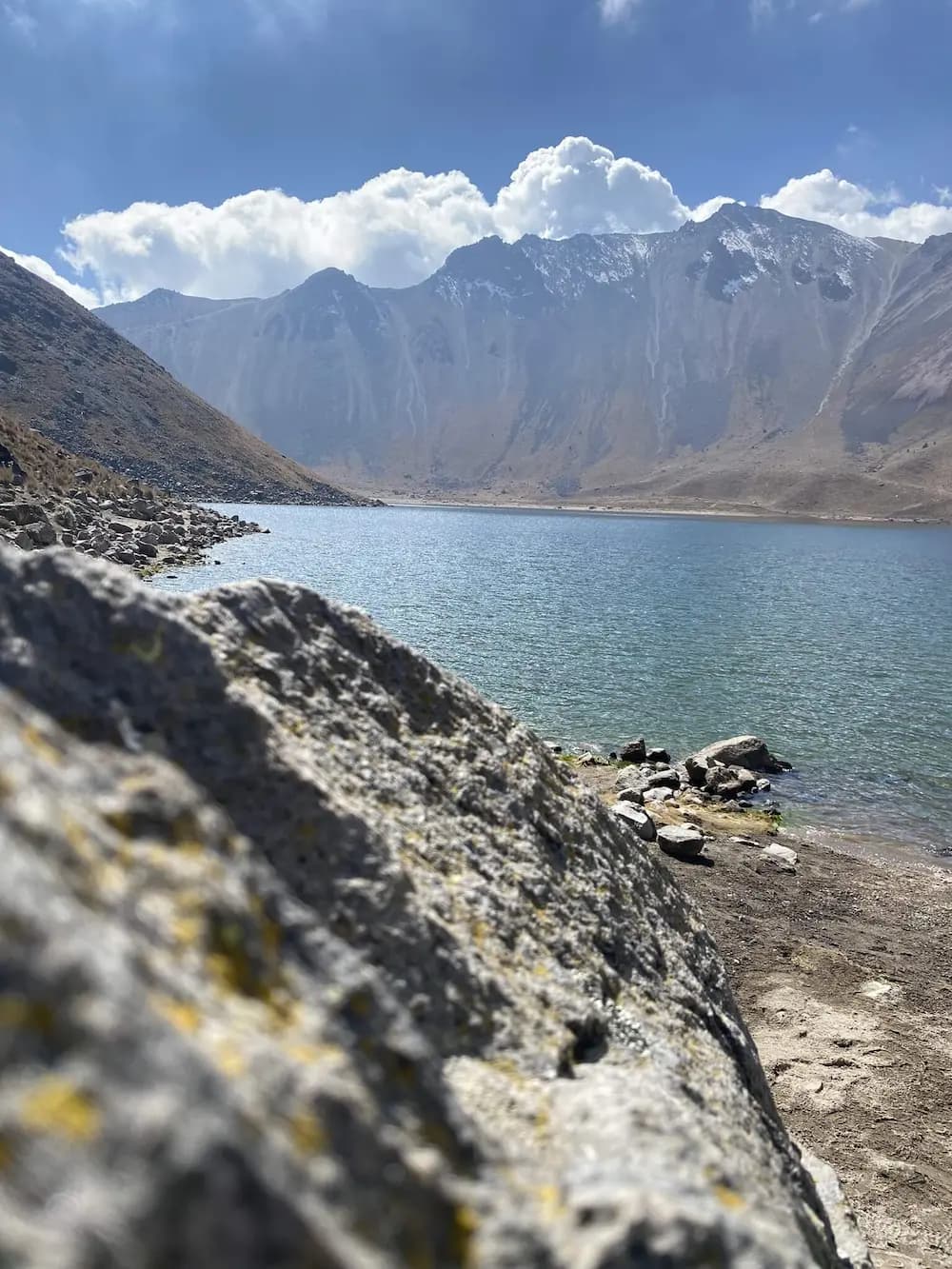 A photograph of a lake surrounded by mountains in Mexico.