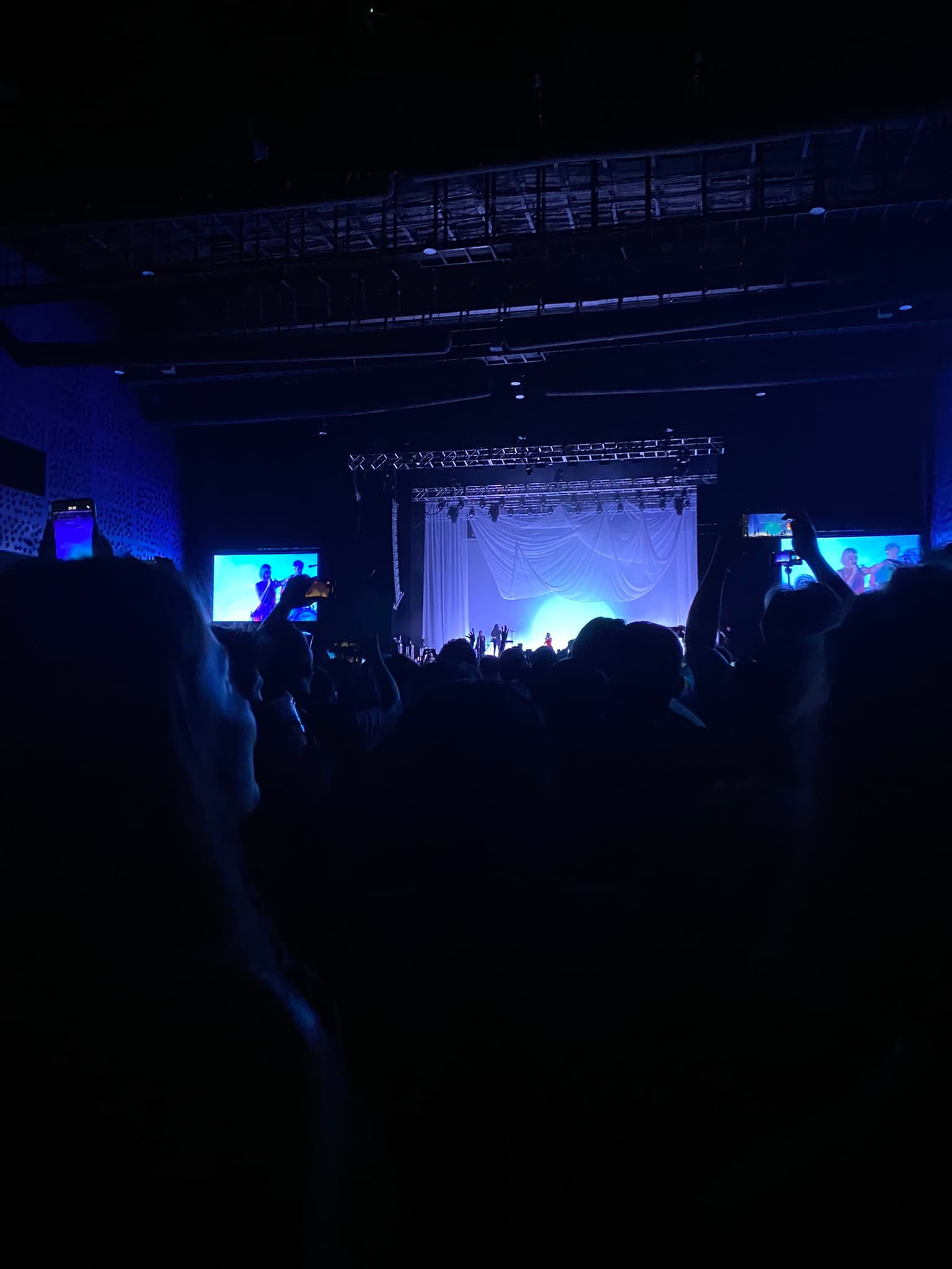 Photograph of the stage at an Aurora concert taken from the audience.